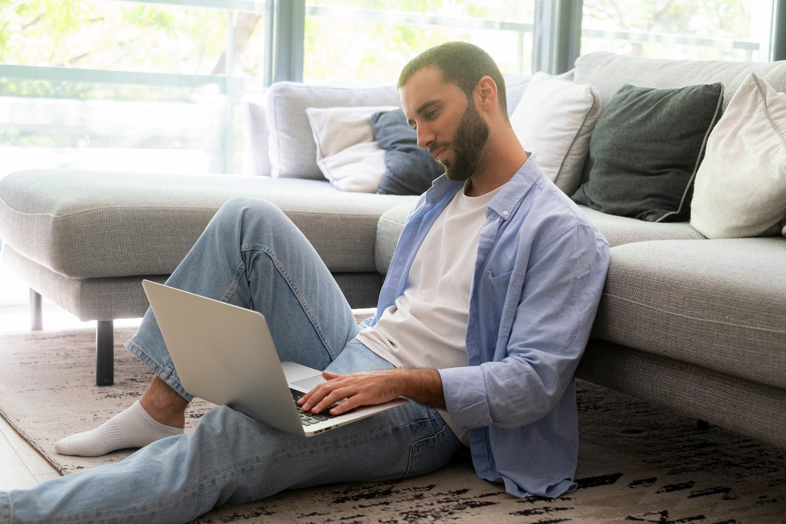 Person reading on a laptop in a relaxed setting, reflecting uninterrupted language learning